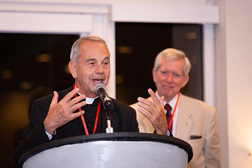 Albert Massey III, a member of the St. Thomas More Society board of governors, right, listens as Msgr. James Dixon speaks concerning his Archbishop Edward McCarthy Award for 2017. Msgr. Dixon was unable to receive the award at last year's event.