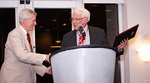 Albert Massey III, a member of the St. Thomas More Society board of governors, left, presents Cardinal Gibbons High School Principal Paul D. Ott with the 2018 Archbishop Edward A. McCarthy Award, posthumously given to the late Piarist Father Oscar G. Alonso, a priest who served at the school.