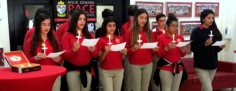 New members of Pace High School's National Spanish Honor Society recite the organizationÕs pledge at their induction ceremony June 1.