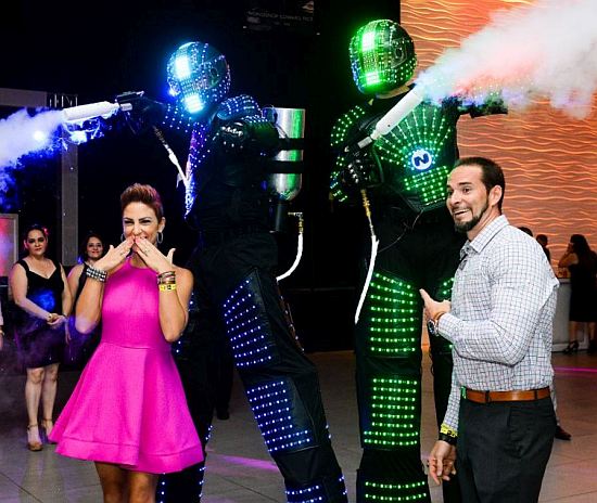 Kristina Bergolla Delgado, of Pace High School's class of 1998, and Danny Delgado, from the class of 1997, enjoy the robotic performers at the school's first alumni prom.