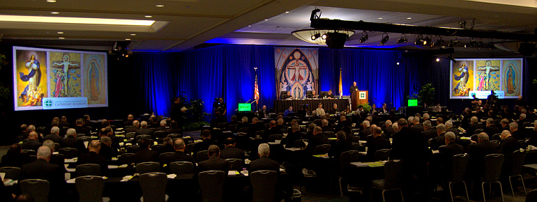 Projected images of religious art form twin backdrops for the semiannual meeting of the United States Conference of Catholic Bishops, this week in Fort Lauderdale.