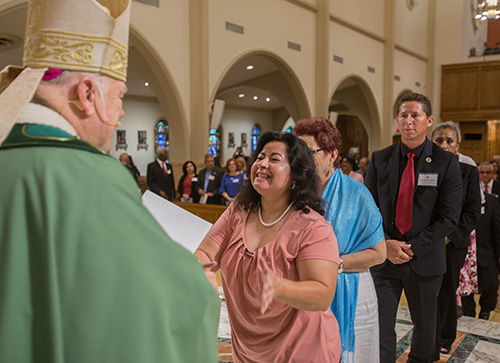 Viviana Mabel Felicito receives her certificate during the commissioning Mass, June 9 at St. Mary Cathedral.