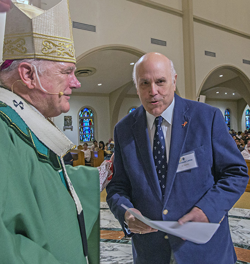 Armando Larrea of St. Timothy Parish in Miami, who serves in ministry to the sick, specifically people with AIDS, receives his certificate during the commissioning Mass, June 9 at St. Mary Cathedral.