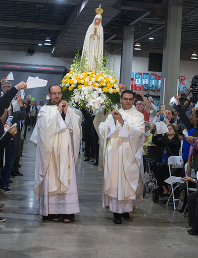 Priests carry the statue of Our Lady of Fatima into Mass during the Third International Congress in Honor of the Hearts of Jesus and Mary.