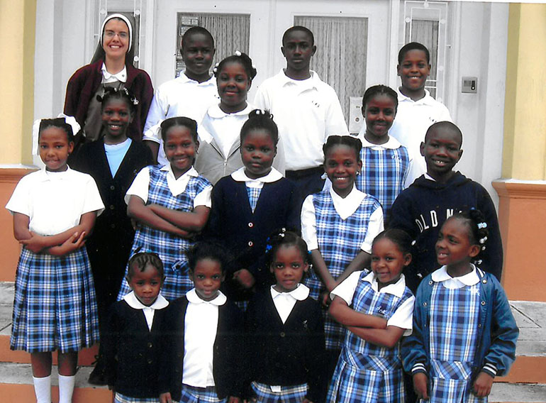 Younger days: A photo of Eudens (second row, from the bottom, far right), and Tajmara (third row, from the bottom, far left) with classmates from St. Mary Cathedral School who were also survivors of the earthquake in Haiti. Accompanying them is Principal Sister Michelle Fernandez, of the Servants of the Pierced Hearts of Jesus and Mary.