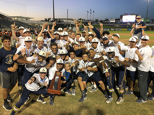 St. Thomas Aquinas High School's baseball players and coaches pose with their trophy after an 8-4 victory over Sarasota to claim their first state championship since 2003. The team ended the season with a 27-3 record.
