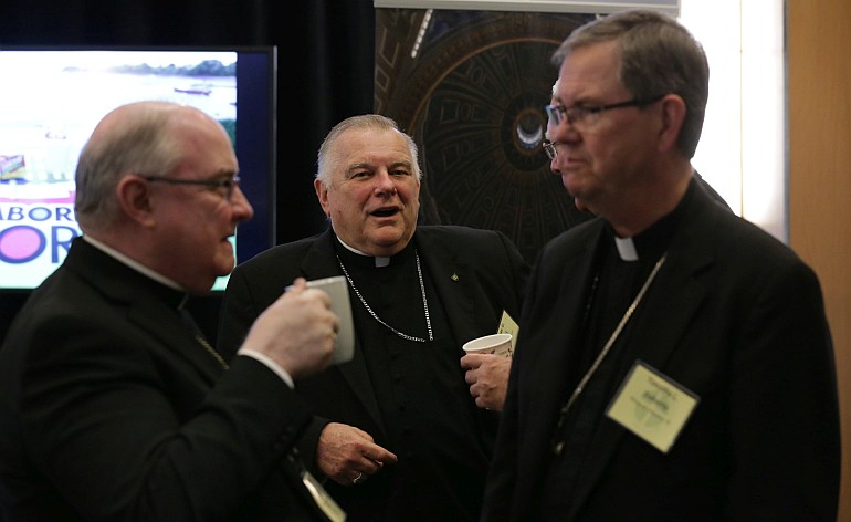 Archbishop Wenski chats with fellow bishops during a break at the spring meeting of the United States Conference of Catholic Bishops in Fort Lauderdale.