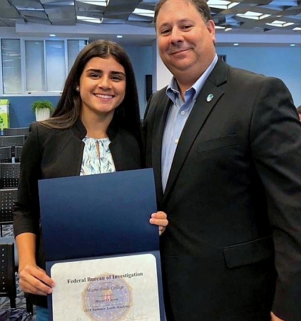 Pace Junior Mayerli Cayon, who took the recent the FBI Summer Youth Academy, is photographed with Nelson Rodriguez, a Miami Lakes councilman and a member of the FBI Miami Citizens Academy Alumni Association.