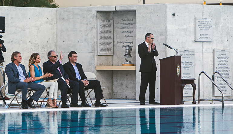 Phil Fernandez, Belen development director, applauds the Zumpano family seated beside him, from left: Daniel, Rosana, Joe, and Carlos.