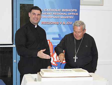 After his talk, Bishop Octavio Ruiz Arenas, secretary of the Pontifical Council for the New Evangelization, cuts a cake marking the 40th anniversary of SEPI, the SouthEast Pastoral Institute. Standing at left is Father Rafael Capó, director of SEPI.
