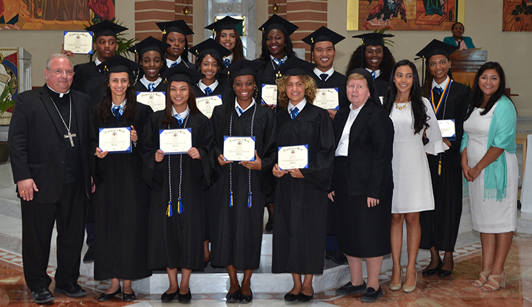 2018 graduates of Holy Family Academy and the Archdiocese of Miami Virtual Catholic School in the Turks and Caicos Islands pose for a photo with Bishop Peter Baldacchino, far left, Sister Elizabeth Worley of the Sisters of St. Joseph, archdiocesan chancellor and COO, as well as their 12th grade teacher and principal. 
The Turks and Caicos educational system provides education through the 11th grade. In order to qualify for U.S. universities, the students of Holy Family Academy complete their 12th grade via the ADOM Virtual School, gathering daily as a group at the academy's classrooms.