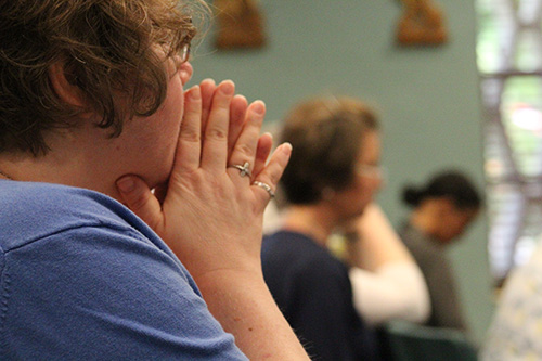 A consecrated virgin prays during Mass July 8 at MorningStar Renewal Center in Pinecrest.