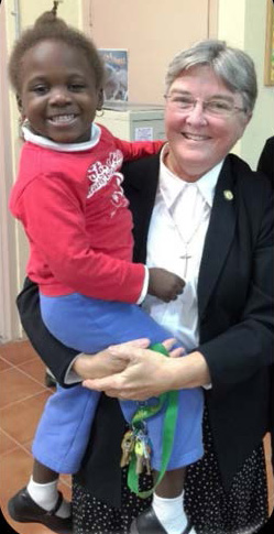 Sister Kathleen Carr is seen here with one of her students at St. James School in North Miami.