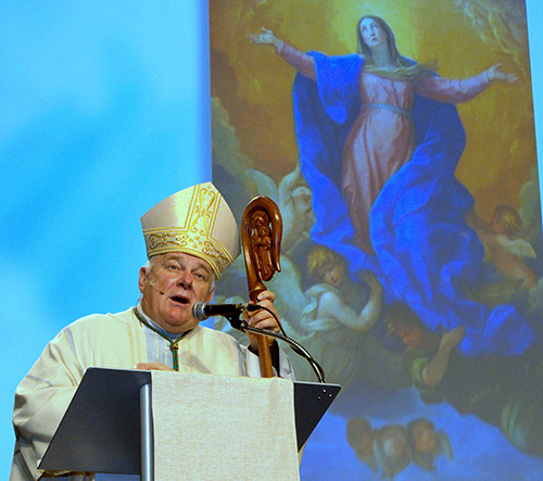 Archbishop Thomas Wenski preaches under a painting of the Assumption of Mary during the back-to-school conference for archdiocesan educators.