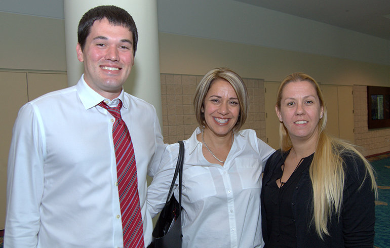 Three teachers from St. Mark School, Southwest Ranches, pose during the back-to-school conference for archdiocesan educators. From left are Ryan Hinsz, Elena Toyos and Kelly Musselman.