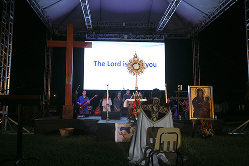 El Arzobispo de Panamá, José Domingo Ulloa dirige a los participantes en oración ante el Santísimo Sacramento, durante la vigilia de oración del 22 de agosto con la cruz y el icono de la JMJ.