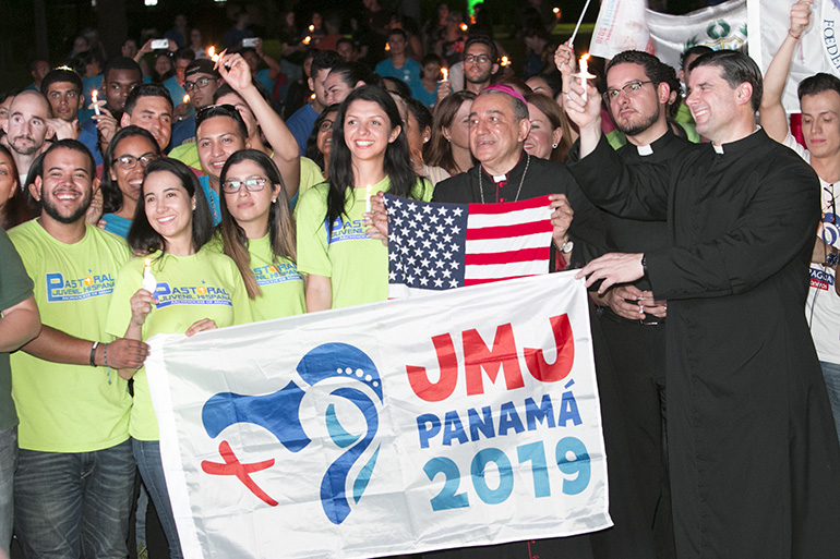 Archbishop Jose Domingo Ulloa of Panama poses for a photo with young people from South Florida who will be attending World Youth Day in Panama in January. Next to him are Father Bryan Garcia and, far right, Father Rafael Capo. Archbishop Ulloa, joined by Archbishop Thomas Wenski, Auxiliary Bishop Peter Baldacchino, Pueblo Bishop Emeritus Fernando Isern and priests from St. John Vianney Seminary and the archdiocese, celebrated Mass at the seminary the evening of Aug. 22 to pray for priests and religious. The Mass was followed by a vigil on the grounds of the seminary with the World Youth Day Cross and icon, attended by about 300 people.