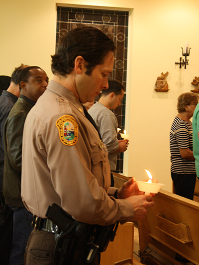 Miami Dade Police Department Major Jesus Ramirez prays for those afflicted by addition during the traditional Latin Mass offered to end the opioid epidemic. The Mass was celebrated at Mission La Milagrosa on Feb. 2, 2018, feast of the Purification of the Blessed Virgin Mary.