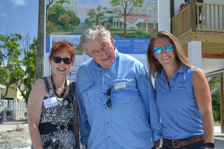 Michele McHale-Pickard of the Florida Keys Community Land Trust, left, poses with Chuck Brush, president of the South Miami-Dade Council of the St. Vincent de Paul Society, and Emily Nixon, deputy director of the SOS Foundation, at the dedication of the first of four Keys Cottages.