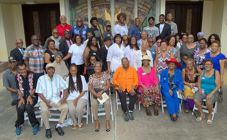 Former members of St. George Church pose for a final shot in front of the building before its planned demolition in August 2018.