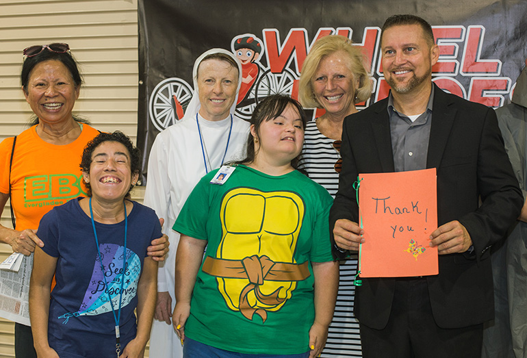 Marian Center students and staff thank the non-profits for their cycle donation. Posing, from left: JoJo Russo, Everglades Bicycle board member, Rosita Petreck, Marian Center student, Sister Lidia Valli, Marian Center executive director, Valerie Virgil, student, Sue Kawalerski, Everglades Bicycle Club president and Anthony DiNito, founder of Wheel Heroes.