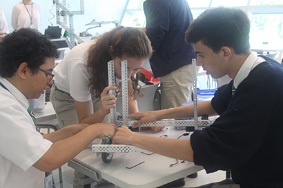 Seniors in St. Brendan's robotics class build a press forklift in the STEM lab; from left: Jacob Angel, Mariana Rogers and Héctor Marcos.