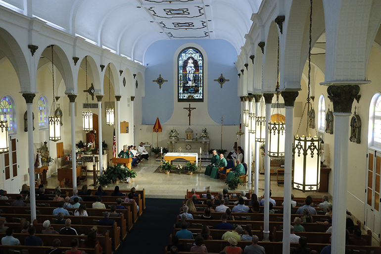 View from the choir loft: Archbishop Thomas Wenski preaches during vigil Mass at the Basilica of St. Mary Star of the Sea Sept. 15. He traveled to Key West to bless and dedicate the new gym built for The Basilica School of St. Mary Star of the Sea.