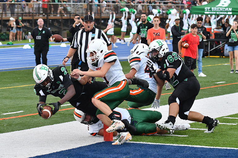 Sabres' freshman running back Leonard Smith (#2) dives for the touchdown during St. Brendan High's first varsity football game in the school's  43-year history. St. Brendan won its opening game against Pinecrest 28-0.