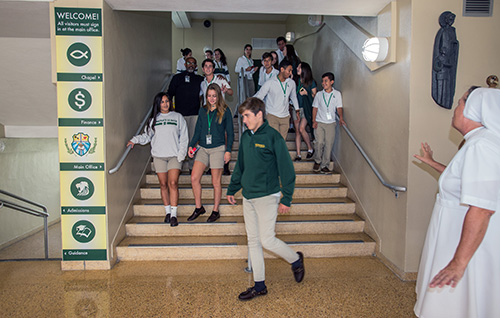 Students switch classes under the watchful eye of Immaculata-LaSalle's principal, Salesian Sister Kim Keraitis.