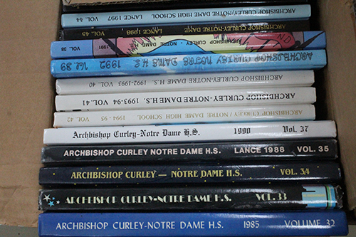 Dozens of yearbooks from Archbishop Curley Notre Dame High are now housed at Msgr. Edward Pace High, where they will be kept in the memorabilia room.
