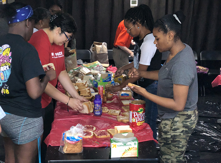 Students from Msgr. Edward Pace High and Chaminade Madonna College Prep prepare sandwiches during Hunger Fest 2018. The retreat, which was brought over as a tradition from Archbishop Curley-Notre Dame High, celebrated its 22nd year at its new home in Pace.