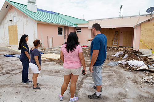 Volunteers from parishes throughout the Archdiocese of Miami inspect the grounds in September 2017 at the archdiocesan church most devastated by Hurricane Irma, St. Peter the Fisherman in Big Pine Key. The church was deemed unusable.