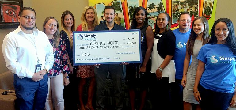 Members of Camillus House and the Simply Healthcare Foundation gather Oct. 4 for presentation of a $ 100,000 grant to fight opioid addiction and mental health problems among the homeless.