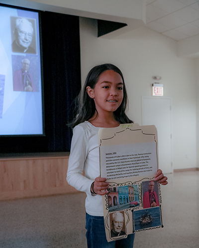 Students at Sts. Peter and Paul School in Miami brought archdiocesan history to life using photos and posters to mark the archdiocese's 60th anniversary.