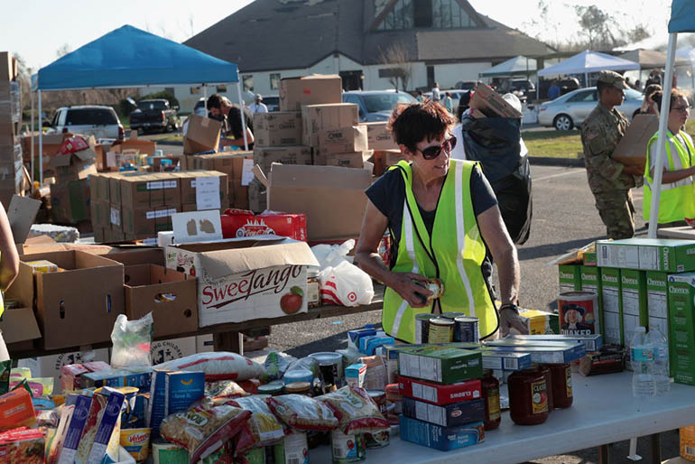 Volunteers help distribute food, water, cleaning supplies and other necessities to victims of Hurricane Michael at an aid distribution point on October 15, 2018 in Panama City, Florida. Michael slammed into the Florida Panhandle on October 10 as a Category 4 storm with sustained winds of 155 mph. (Getty Images)