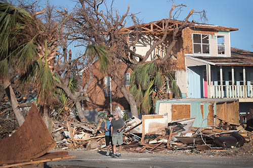 Dan and Jeri Clark look over damage from Hurricane Michael on October 16, 2018 in Mexico Beach, Florida. Hurricane Michael slammed into the Florida Panhandle on October 10, as a category 4 storm, claiming at least 19 lives and causing massive damage. (Getty Images)