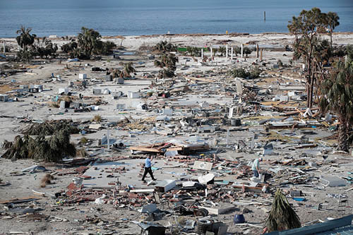 A man walks through a beachfront neighborhood that was decimated by Hurricane Michael on October 16, 2018 in Mexico Beach, Florida. The neighborhood, which had homes most of the way to the beach before the storm, is now mostly flattened. Hurricane Michael slammed into the Florida Panhandle on October 10, as a category 4 storm, claiming at least 19 lives and causing massive damage. (Getty Images)