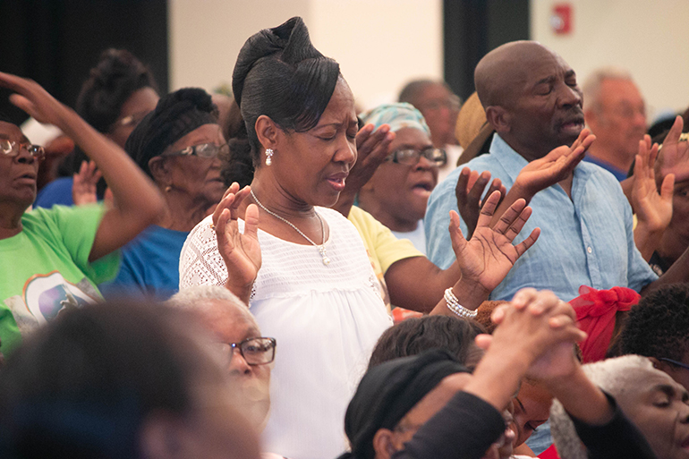 People pray during the fifth night of Jericho 2018 at Notre Dame d'Haiti Mission, Miami.