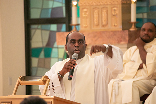 Father Reginald Jean-Mary, who began the Jericho tradition at Notre Dame d'Haiti 17 years ago, addresses participants on the fifth night of the seven-day spiritual renewal event.