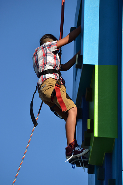 Gustavo Avila, 9, tackles a climbing wall during the archdiocese’s 60th anniversary picnic at Nativity Church in Hollywood.