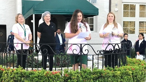 St. Theresa School seventh-grader Anabelle Cejas, center, prays for a breast cancer cure. With her, from left, are Lourdes Ambros, Adriana Cora, volunteer executive vice president of La Liga Contra El Cancer, and Cristina Guanche-Martinez, director of Curriculum and Student Council moderator.