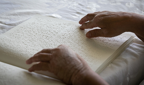 Coconut Creek resident Lygia Bohan, who attends All Saints Parish in Sunrise, reads Catholic materials in Braille, including the Sunday Mass readings which she reviews in advance of attending church.