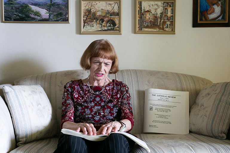 Cuban-American Adelina Maideski, a former gift store employee at Miami International Airport who attends St. Martha Parish in Miami Shores, reads braille Catholic materials at her residence.