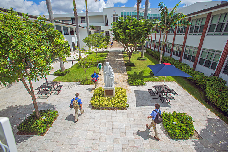 Students walk through the patio of Christopher Columbus High School in Miami, which is celebrating its 60th anniversary this year.