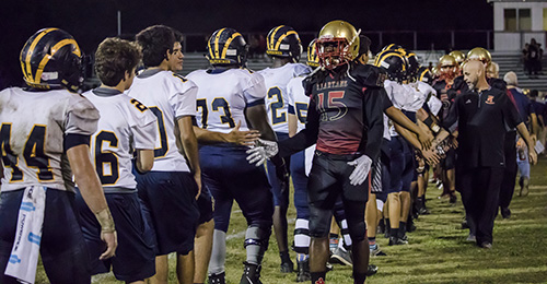 Pace Spartans and Belen Wolverines shake hands at the end of the game, which Belen won 32-7.