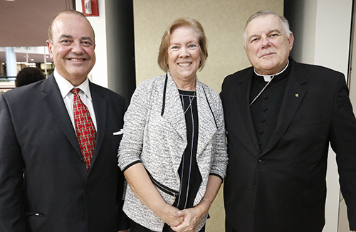 Joan Crown poses with incoming Respect Life Director Juan Guerra and Archbishop Thomas Wenski, during her retirement party at the Pastoral Center Oct. 4.