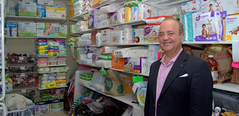 Juan Guerra, the new executive director of the archdiocesan Respect Life Office, shows a storeroom for baby care supplies.