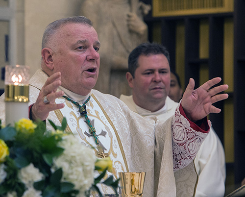 Archbishop Thomas Wenski and Father Rolando Cabrera, St. Catherine of Siena administrator, celebrate Mass the 50th anniversary Mass.