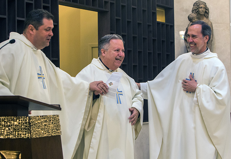 Current administrator Father Rolando Cabrera, left, and former pastors Father Juan Sosa and Father Alejandro Rodriguez Artola, share a laugh during St. Catherine of Siena Church's 50th anniversary Mass.