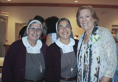 Former members of the Archdiocese of Miami Respect Life ministry, Sister Carmen Ors, left, and Sister Maria Jose Socias, of the Servants of the Pierced Hearts of Jesus and Mary, pose for a photo with Joan Crown at her retirement reception at St. David Parish Oct. 20.